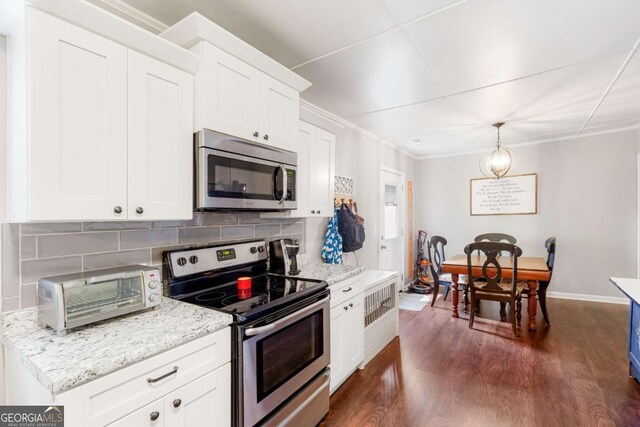 632 Lawson St, Bremen, GA 30110 - kitchen with appliances with stainless steel finishes, decorative backsplash, white cabinetry, baseboards, and crown molding