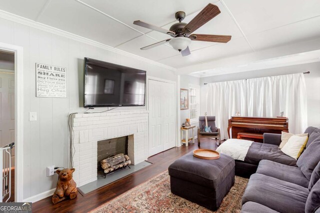632 Lawson St, Bremen, GA 30110 - living area featuring wood finished floors, ceiling fan, ornamental molding, and a brick fireplace