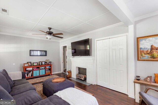 632 Lawson St, Bremen, GA 30110 - living room with dark wood-style flooring, ceiling fan, crown molding, and a fireplace