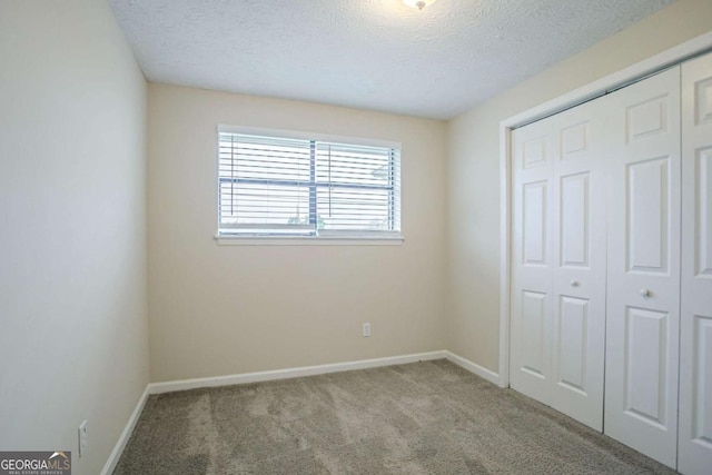 2290 Pope Rd, Douglasville, GA 30135 - unfurnished bedroom with carpet floors, a textured ceiling, and a closet
