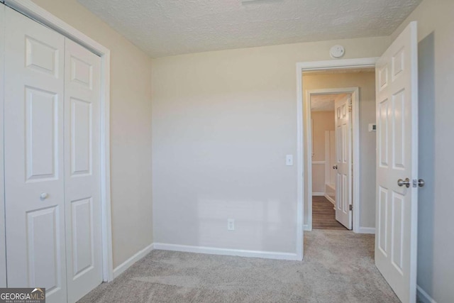 2290 Pope Rd, Douglasville, GA 30135 - unfurnished bedroom featuring carpet floors, a closet, and a textured ceiling