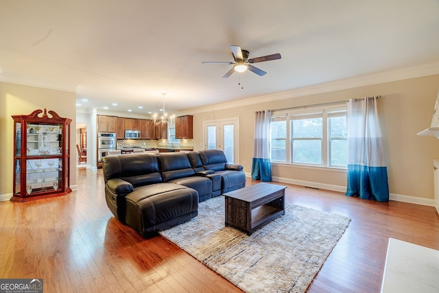 3623 Terrah Point Dr, Duluth, GA 30097 - living room with ornamental molding, light wood finished floors, ceiling fan, a chandelier, and baseboards