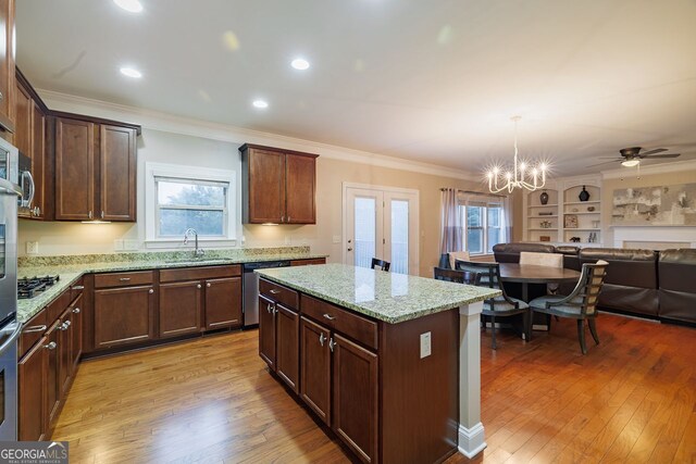 3623 Terrah Point Dr, Duluth, GA 30097 - kitchen featuring a sink, open floor plan, stainless steel dishwasher, light stone counters, and crown molding