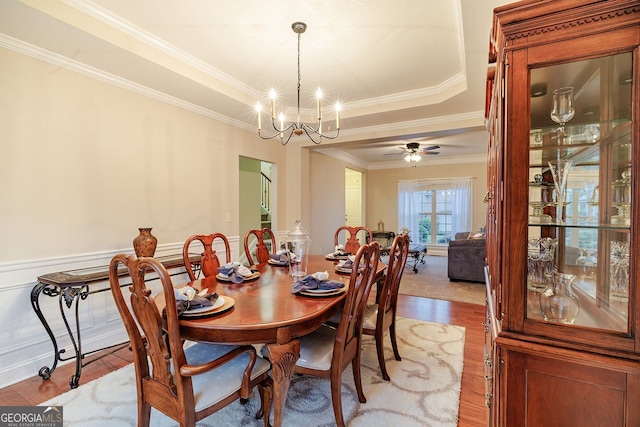 3623 Terrah Point Dr, Duluth, GA 30097 - dining room featuring light wood finished floors, crown molding, a chandelier, a raised ceiling, and a ceiling fan
