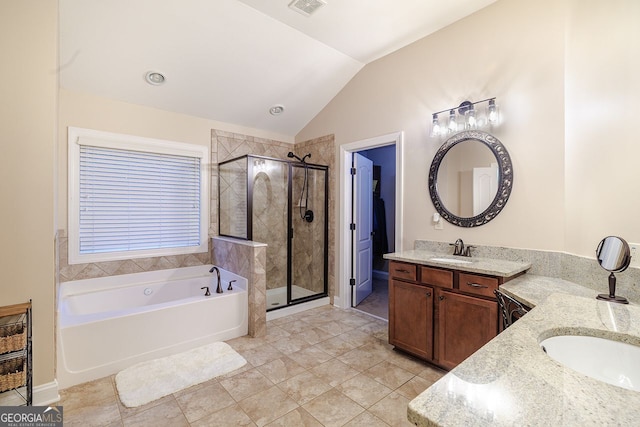 3623 Terrah Point Dr, Duluth, GA 30097 - full bathroom with vaulted ceiling, two vanities, a shower stall, a garden tub, and tile patterned floors