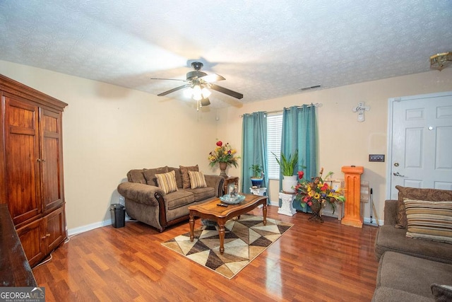1346 Revelstoke Cv, Riverdale, GA 30296 - living room featuring a ceiling fan, wood finished floors, baseboards, and a textured ceiling