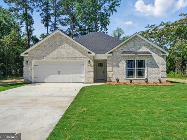 116 Fred Ct, Macon, GA 31216 - view of front of house featuring an attached garage, concrete driveway, and a front yard