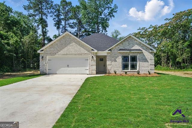 116 Fred Ct, Macon, GA 31216 - view of front facade featuring driveway, a garage, a front lawn, and brick siding