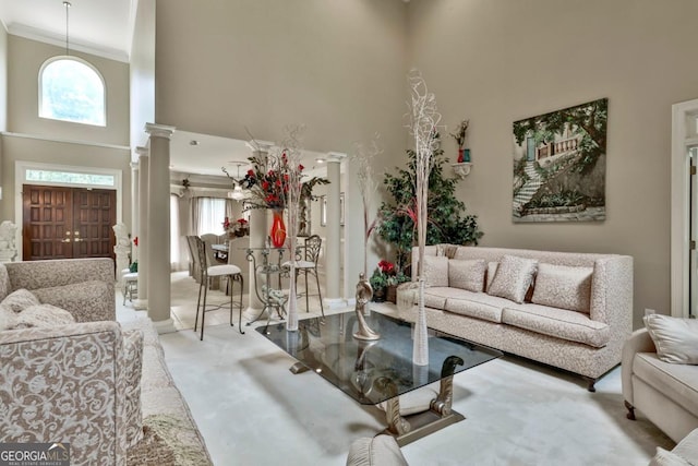 226 Long Island Dr, Whitesburg, GA 30185 - living room with a high ceiling, ornate columns, carpet, and crown molding