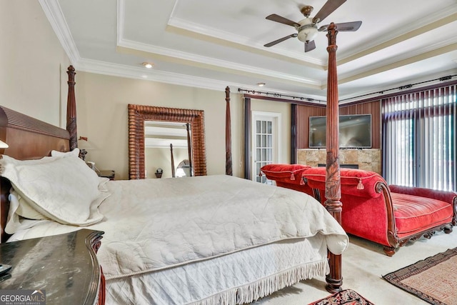226 Long Island Dr, Whitesburg, GA 30185 - carpeted bedroom featuring a raised ceiling, ornamental molding, a tiled fireplace, and a ceiling fan