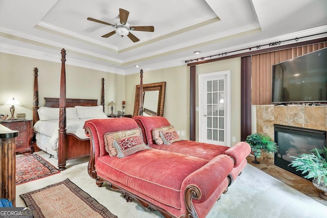 226 Long Island Dr, Whitesburg, GA 30185 - bedroom featuring a raised ceiling, crown molding, a tile fireplace, and a ceiling fan