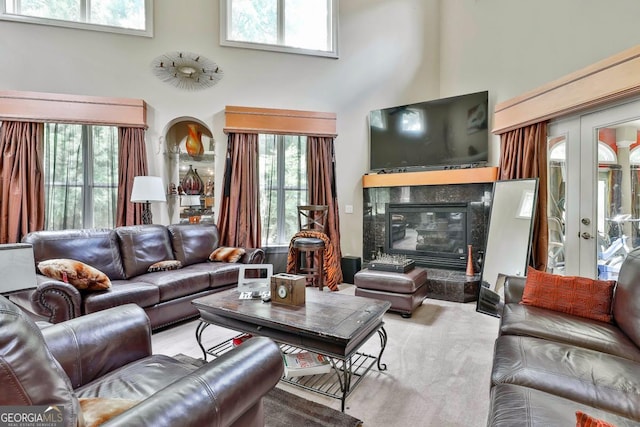 226 Long Island Dr, Whitesburg, GA 30185 - carpeted living area featuring a high ceiling, healthy amount of natural light, a fireplace, and french doors