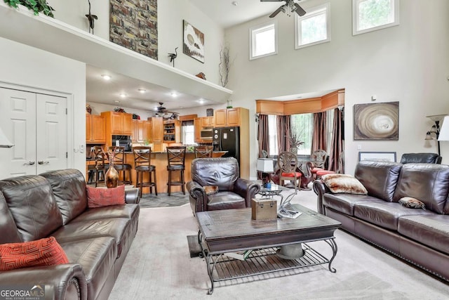 226 Long Island Dr, Whitesburg, GA 30185 - living room with ceiling fan, a high ceiling, and light colored carpet