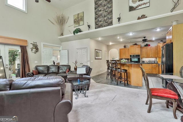 226 Long Island Dr, Whitesburg, GA 30185 - living room featuring a ceiling fan, a high ceiling, and arched walkways