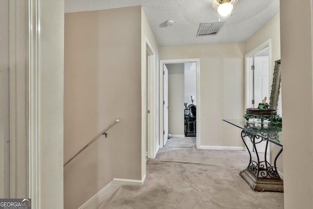 226 Long Island Dr, Whitesburg, GA 30185 - hallway with an upstairs landing, carpet floors, and a textured ceiling