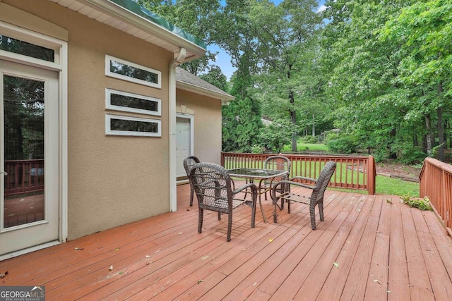 226 Long Island Dr, Whitesburg, GA 30185 - wooden deck with outdoor dining space and view of scattered trees
