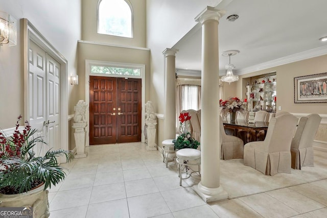 226 Long Island Dr, Whitesburg, GA 30185 - tiled foyer featuring ornate columns, plenty of natural light, crown molding, and a chandelier