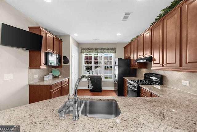 3554 Black Cherry Pt SW, Gainesville, GA 30504 - kitchen featuring black appliances, a sink, brown cabinets, light stone countertops, and recessed lighting