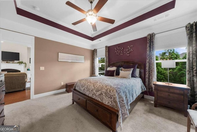 3554 Black Cherry Pt SW, Gainesville, GA 30504 - bedroom with light colored carpet, baseboards, crown molding, a tray ceiling, and ceiling fan