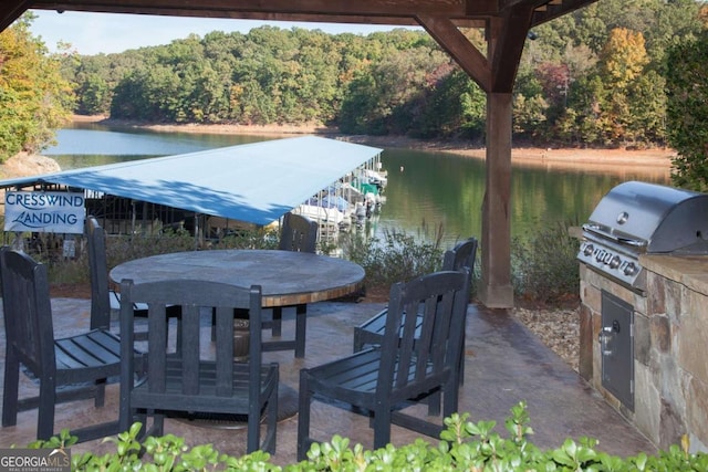 3554 Black Cherry Pt SW, Gainesville, GA 30504 - view of patio / terrace with a forest view, a water view, an outdoor kitchen, and outdoor dining area