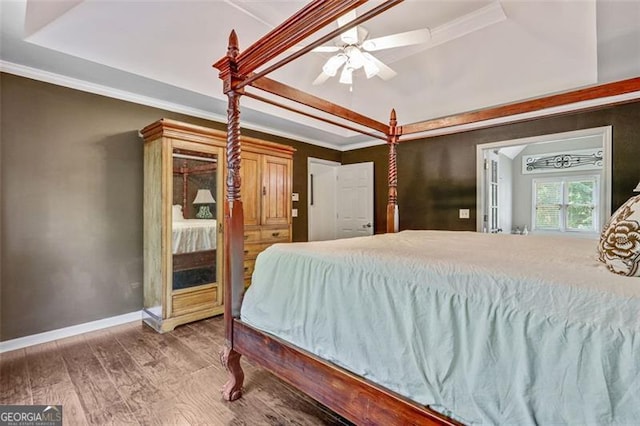 2073 Woodside Park Dr, Woodstock, GA 30188 - bedroom with a tray ceiling, ornamental molding, wood finished floors, baseboards, and ceiling fan