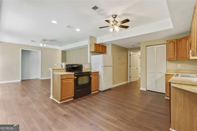 2073 Woodside Park Dr, Woodstock, GA 30188 - kitchen with electric range, freestanding refrigerator, a ceiling fan, light countertops, and recessed lighting