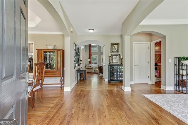 2073 Woodside Park Dr, Woodstock, GA 30188 - foyer entrance featuring light wood-style floors, baseboards, and crown molding