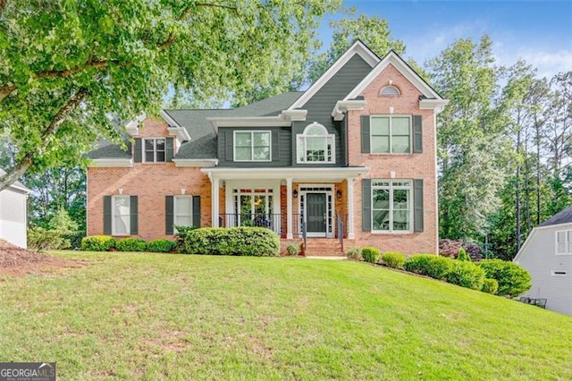 2073 Woodside Park Dr, Woodstock, GA 30188 - view of front of property with brick siding, a front lawn, and covered porch