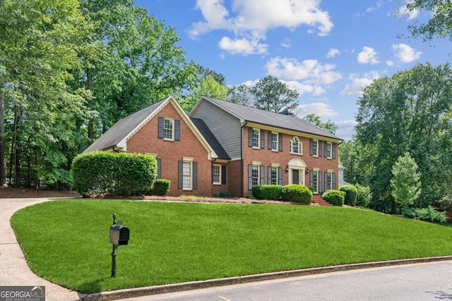 6165 Pin Oak Ln, Alpharetta, GA 30005 - colonial home featuring a front lawn and brick siding