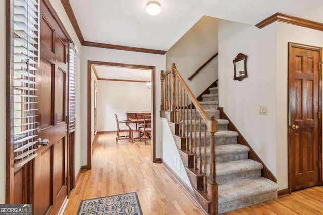 6165 Pin Oak Ln, Alpharetta, GA 30005 - entrance foyer featuring light wood-type flooring, ornamental molding, stairs, and baseboards