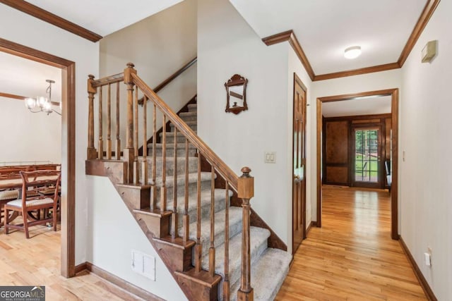 6165 Pin Oak Ln, Alpharetta, GA 30005 - staircase featuring ornamental molding, wood finished floors, a chandelier, and baseboards