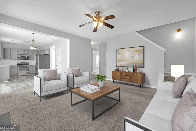 145 Silver Mine Trl, Austell, GA 30168 - living area featuring a ceiling fan, baseboards, and light carpet