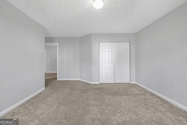 145 Silver Mine Trl, Austell, GA 30168 - unfurnished bedroom featuring carpet floors, baseboards, a closet, and a textured ceiling