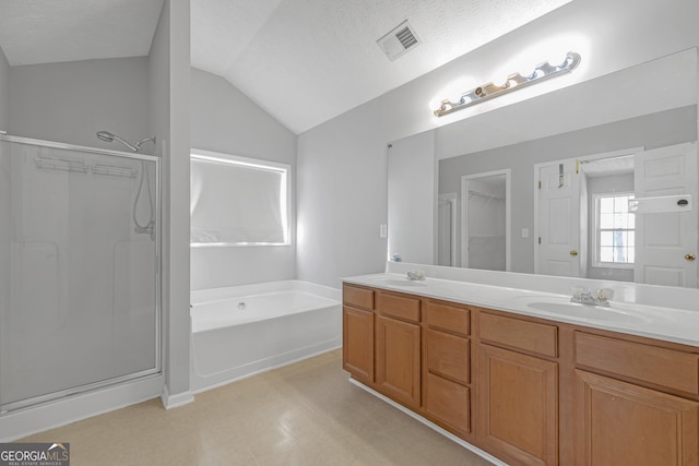 145 Silver Mine Trl, Austell, GA 30168 - full bath with a garden tub, vaulted ceiling, a stall shower, double vanity, and a textured ceiling