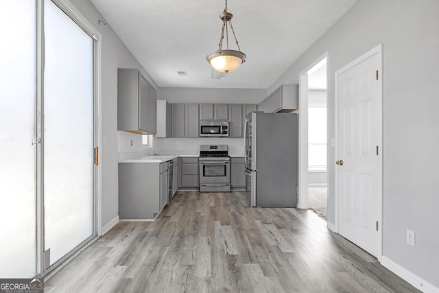 145 Silver Mine Trl, Austell, GA 30168 - kitchen with gray cabinetry, appliances with stainless steel finishes, and light wood-style flooring