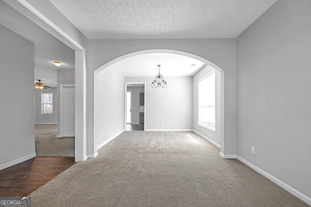 145 Silver Mine Trl, Austell, GA 30168 - empty room with carpet flooring, arched walkways, a chandelier, baseboards, and a ceiling fan