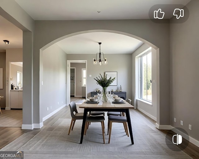 145 Silver Mine Trl, Austell, GA 30168 - dining space featuring arched walkways, wood finished floors, baseboards, and a chandelier