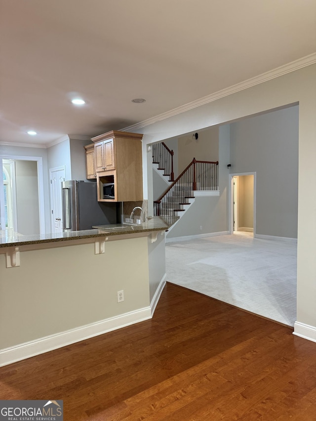2360 Barrington Trace Cir SW, South Fulton, GA 30331 - kitchen with stainless steel appliances, ornamental molding, stone countertops, a kitchen bar, and baseboards