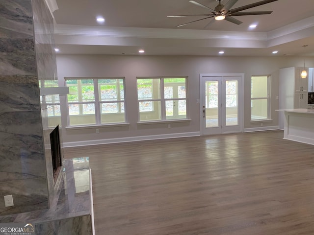 5950 Lynfield Dr, South Fulton, GA 30349 - unfurnished living room featuring ornamental molding, wood finished floors, ceiling fan, baseboards, and a tray ceiling
