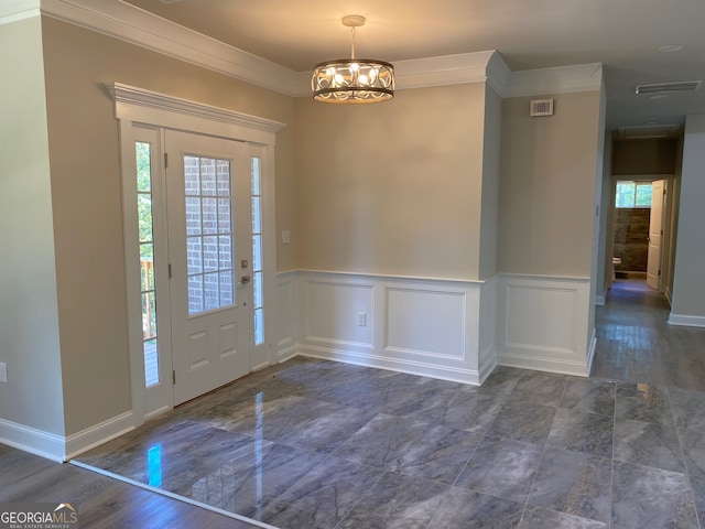 5950 Lynfield Dr, South Fulton, GA 30349 - foyer with ornamental molding, a chandelier, a wainscoted wall, a decorative wall, and baseboards