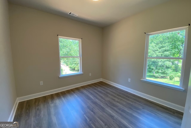 5950 Lynfield Dr, South Fulton, GA 30349 - unfurnished room with healthy amount of natural light, dark wood-style floors, and baseboards