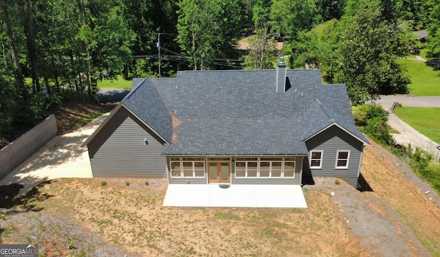 5950 Lynfield Dr, South Fulton, GA 30349 - back of property featuring a patio, roof with shingles, a chimney, a yard, and driveway