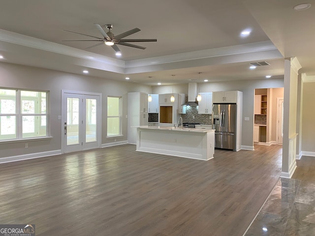 5950 Lynfield Dr, South Fulton, GA 30349 - kitchen with stainless steel fridge with ice dispenser, crown molding, open floor plan, white cabinetry, and recessed lighting