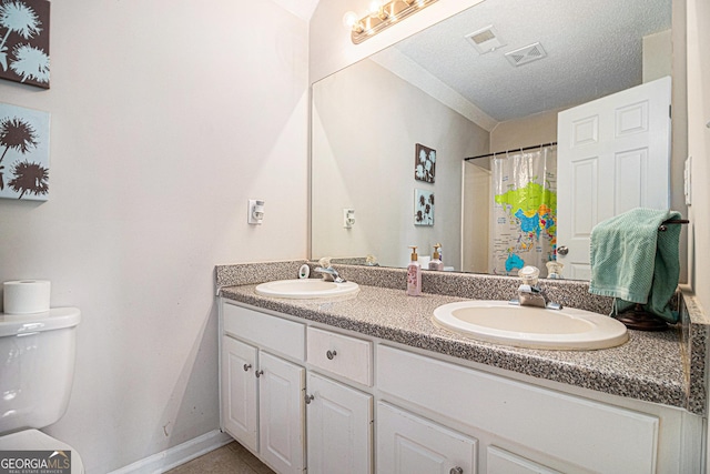 385 Eagles Nest Cir, Carrollton, GA 30116 - bathroom with toilet, double vanity, a textured ceiling, curtained shower, and tile patterned floors