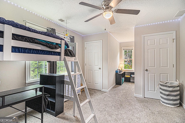 385 Eagles Nest Cir, Carrollton, GA 30116 - carpeted bedroom featuring a textured ceiling, baseboards, and ceiling fan
