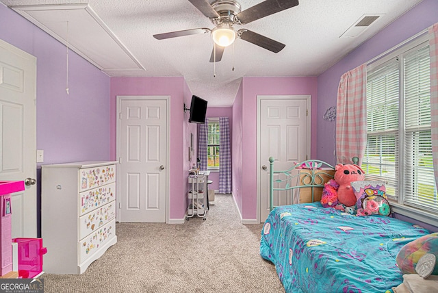385 Eagles Nest Cir, Carrollton, GA 30116 - carpeted bedroom with attic access, a textured ceiling, and a ceiling fan