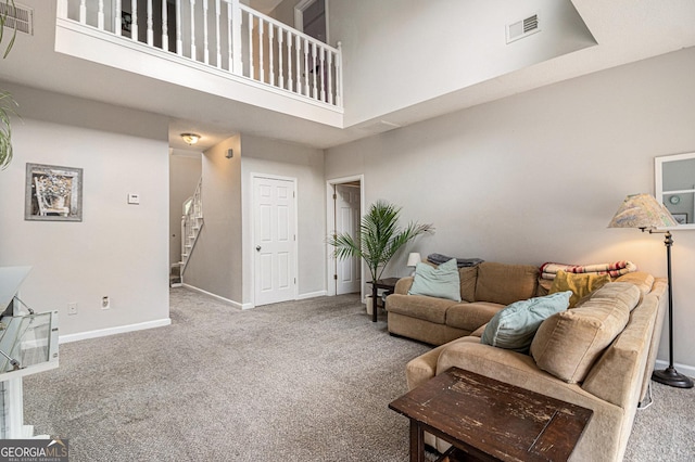 385 Eagles Nest Cir, Carrollton, GA 30116 - carpeted living area with a high ceiling, baseboards, and stairway