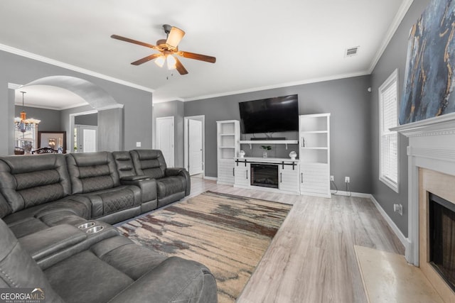 143 Monarch Way, Hiram, GA 30141 - living room featuring a high end fireplace, arched walkways, wood finished floors, a ceiling fan, and a chandelier