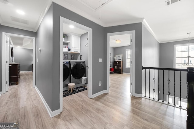 143 Monarch Way, Hiram, GA 30141 - laundry area with washing machine and dryer, attic access, light wood-style flooring, ornamental molding, and cabinet space