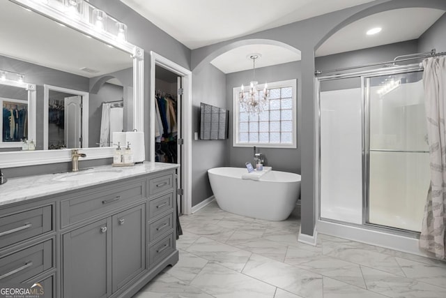 143 Monarch Way, Hiram, GA 30141 - full bathroom with a stall shower, vanity, marble look tiles, a chandelier, and recessed lighting